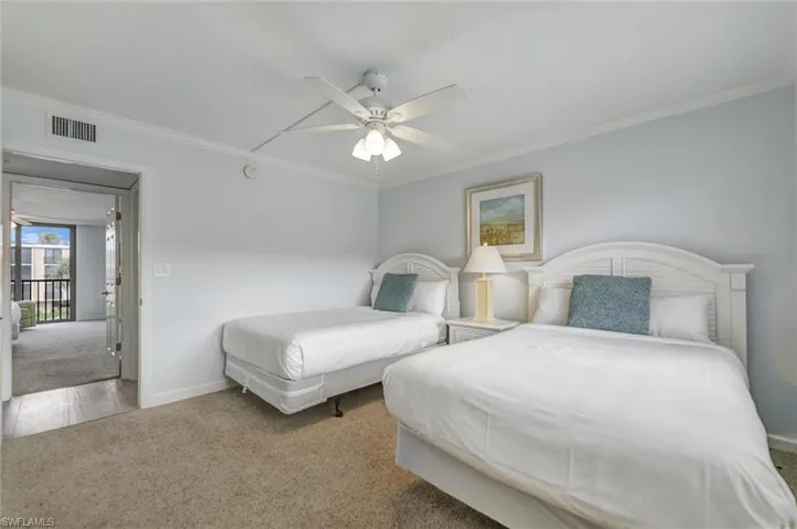 Bedroom featuring carpet flooring, ceiling fan, and ornamental molding