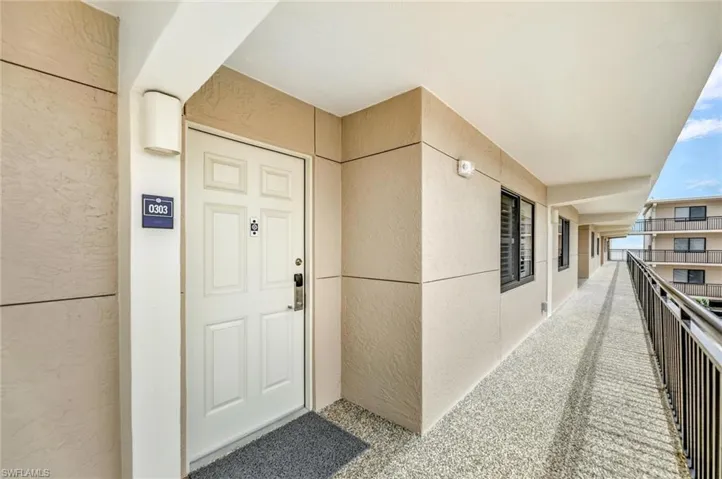 Entrance to property featuring stucco siding