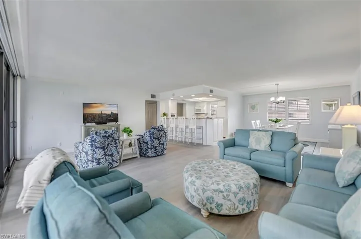 Living area with a chandelier and wood finished floors