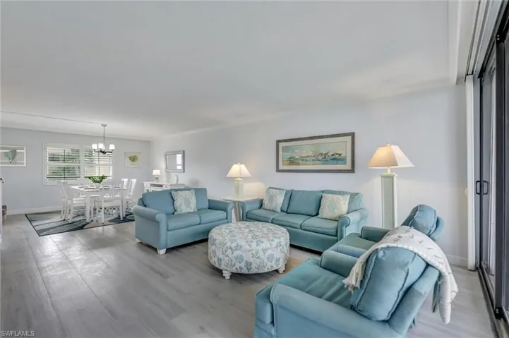 Living area featuring wood finished floors and a chandelier