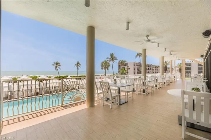 View of patio featuring ceiling fan, a water view, and a community pool