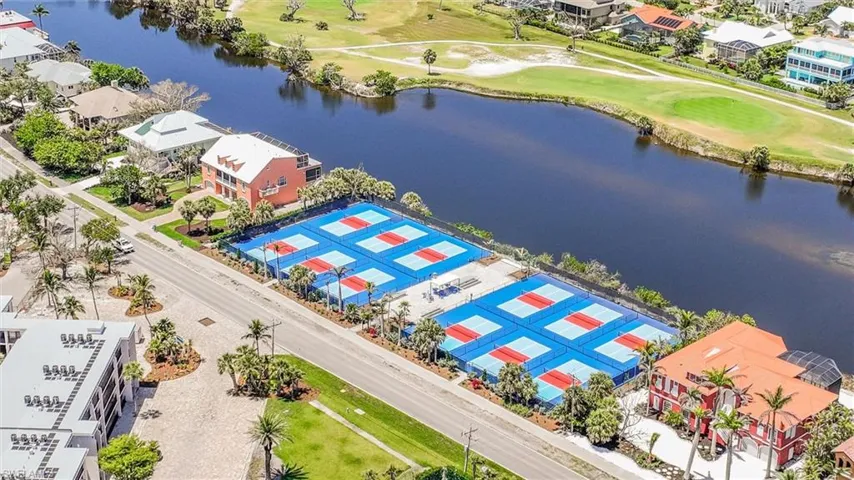 Aerial perspective of suburban area with a large body of water and a local golf course