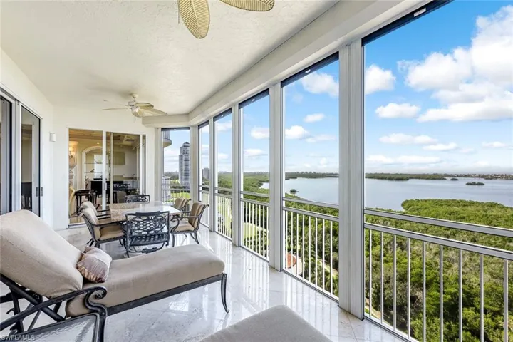 Screened lanai with panoramic water and preserve views.