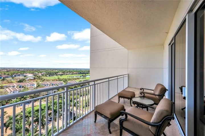 Balcony view overlooking the community and surrounding landscape with open skies and distant horizon lines.