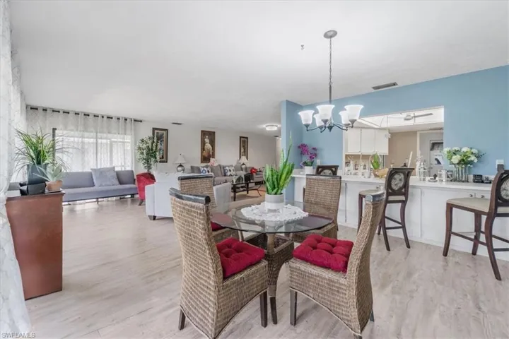 Dining space featuring hanging lights and light wood-style flooring