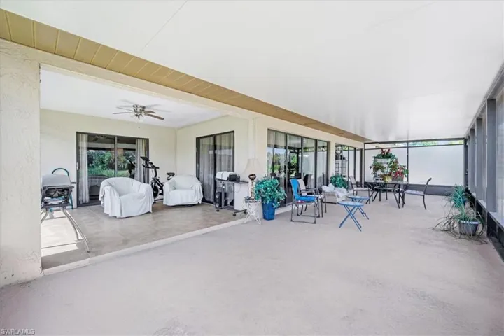 Sunroom featuring ceiling fan and outdoor dining space