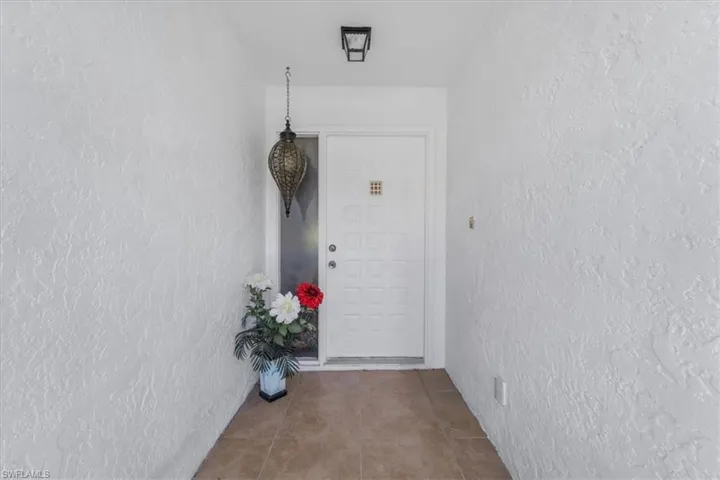 Doorway to property with stucco siding