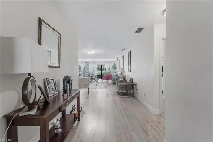Hall with light wood-type flooring and baseboards