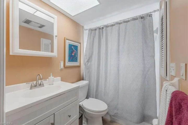 Full bath featuring vanity and a shower with curtain