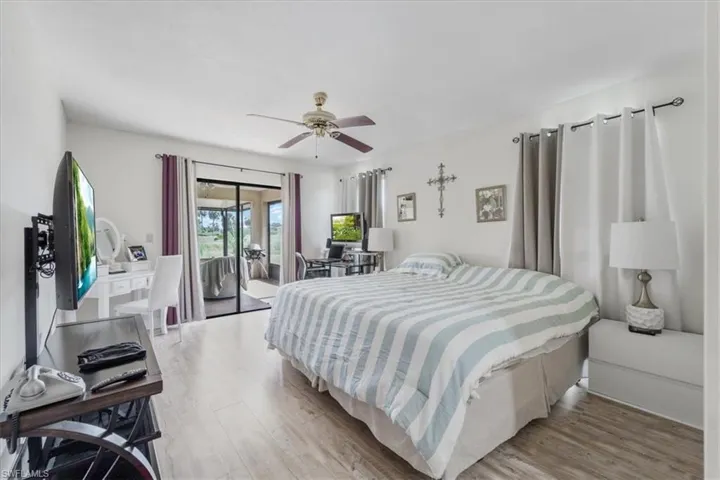 Bedroom featuring light wood-style floors, access to outside, and ceiling fan