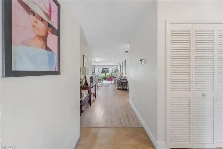 Hall featuring baseboards and light tile patterned floors