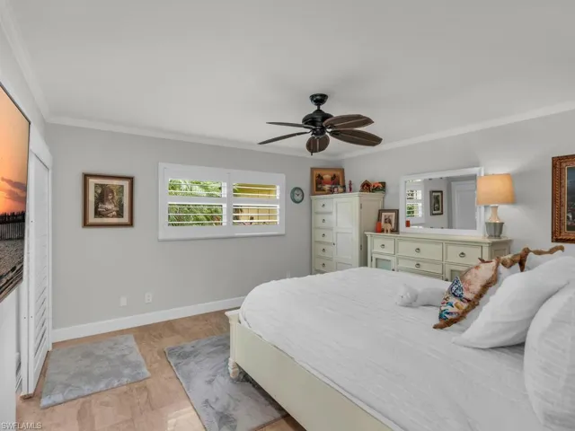 Bedroom featuring ornamental molding and ceiling fan