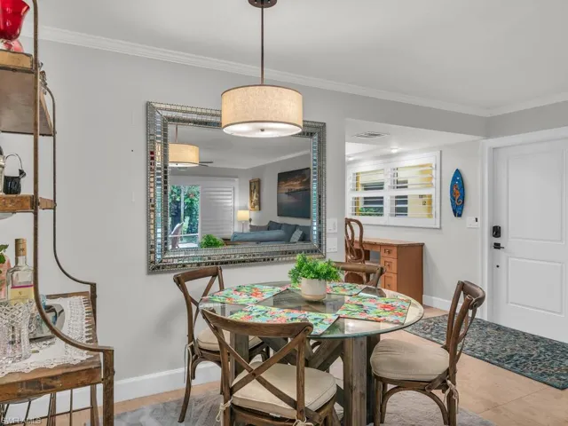 Tiled dining area featuring ornamental molding