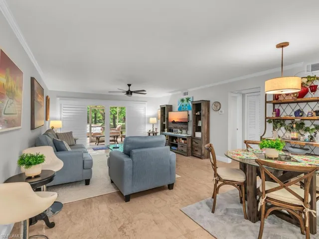 Living room featuring ceiling fan and crown molding