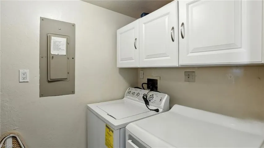 Bathroom featuring vanity, bath / shower combo with glass door, and a closet - Virtually Edited Image