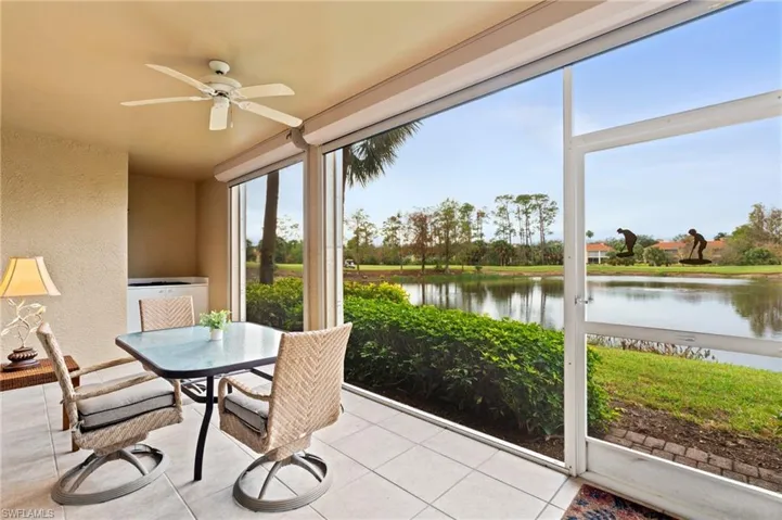 Sunroom / solarium featuring a water view and ceiling fan