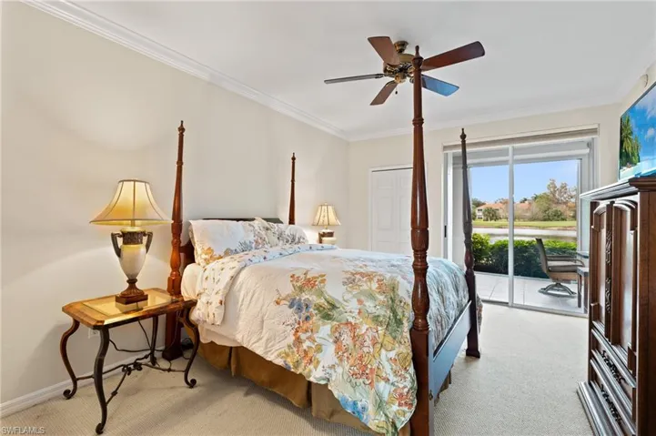 Bedroom featuring ceiling fan, access to exterior, crown molding, light carpet, and a closet