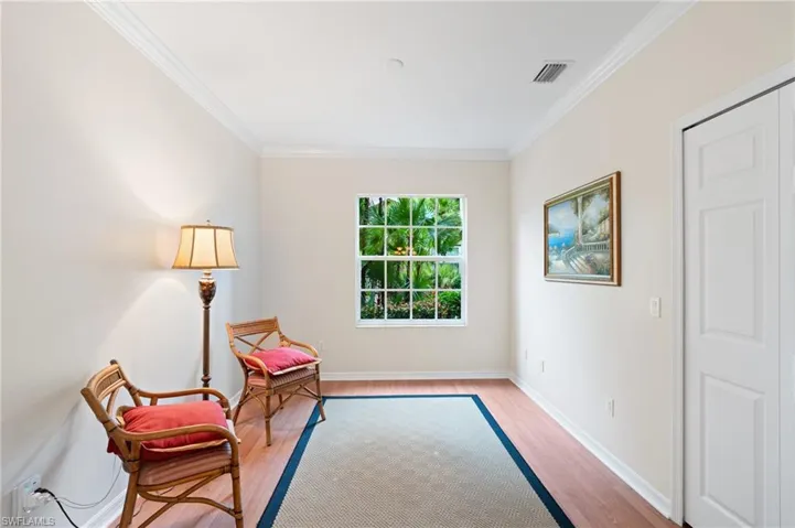 Sitting room featuring light hardwood / wood-style flooring and crown molding