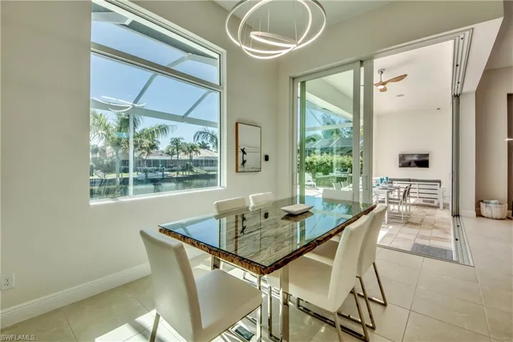 Dining space featuring light tile patterned floors and a ceiling fan