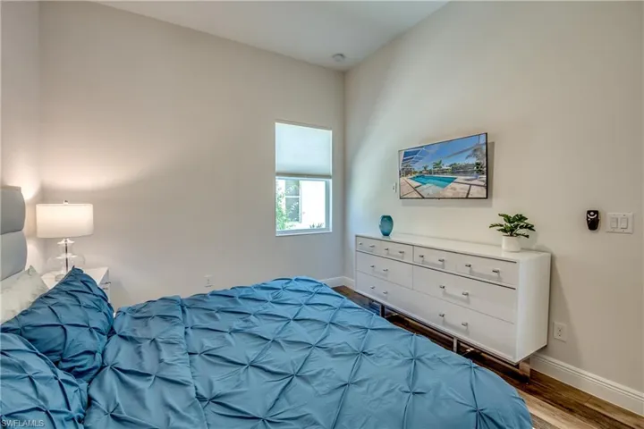 Bedroom with baseboards and wood finished floors