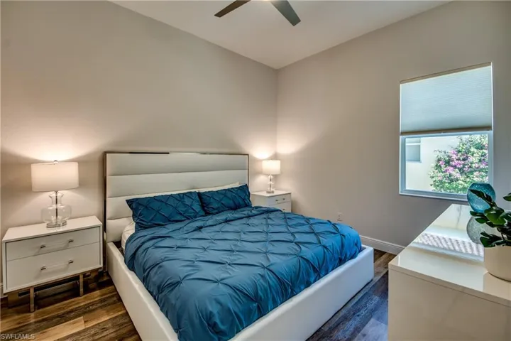Bedroom with dark wood-style flooring and ceiling fan