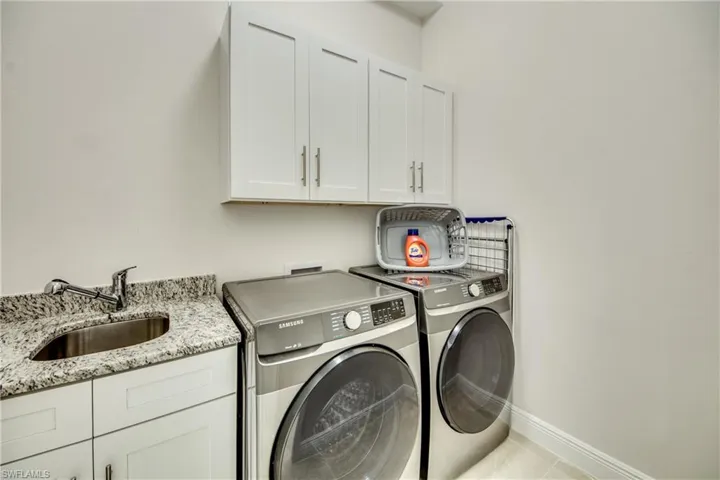 Laundry room featuring cabinet space and washer and dryer