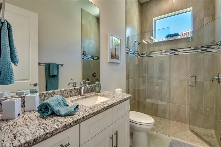 Bathroom featuring vanity and a stall shower