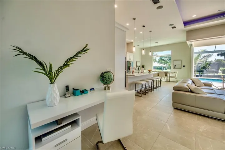 Office with light tile patterned floors and recessed lighting