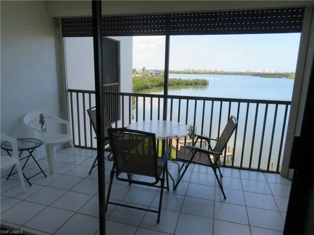 Balcony with a water view and a sunroom
