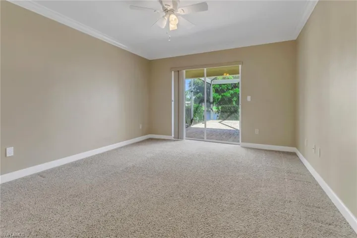 Carpeted empty room with ornamental molding and ceiling fan
