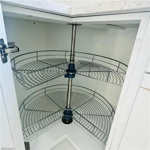 Corner cabinet featuring a two-tier pull-out wire shelving system
