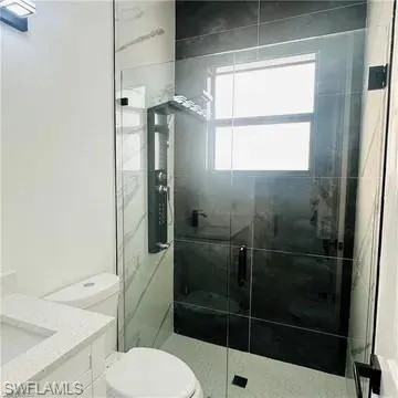 Contemporary bathroom featuring a frameless glass shower enclosure