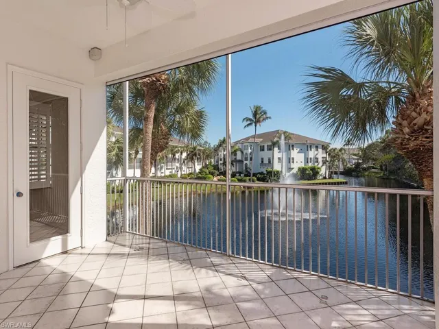 Unfurnished sunroom featuring a water view and a residential view