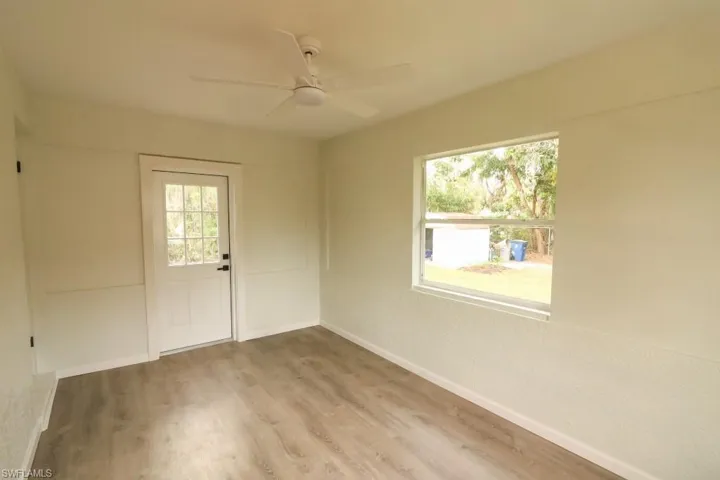 Spare room featuring wood-type flooring and ceiling fan