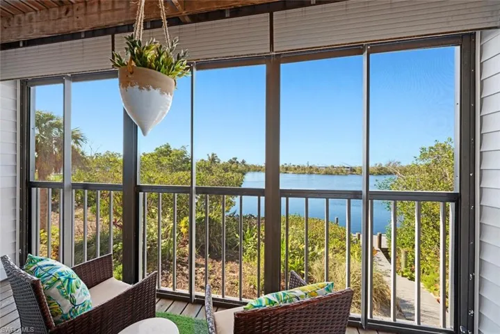 Unfurnished sunroom featuring a water view
