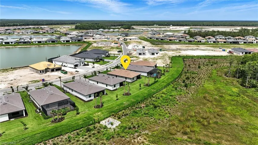 Aerial view of residential area featuring a nearby body of water