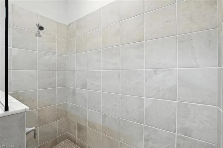 Full bath featuring a tile shower
