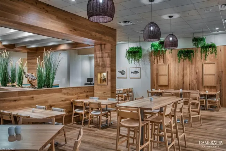 Dining room featuring wood finished floors and wood walls