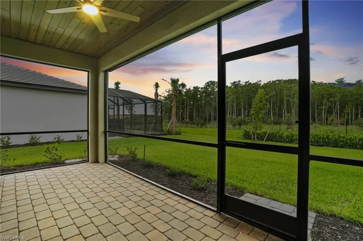 Unfurnished sunroom featuring a ceiling fan