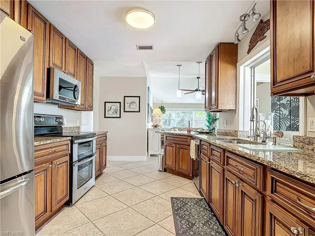 Kitchen with wood cabinets, granite counters and SS appliances