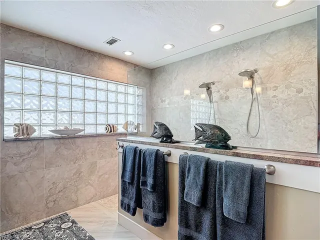 2 shower heads, tiled walls.