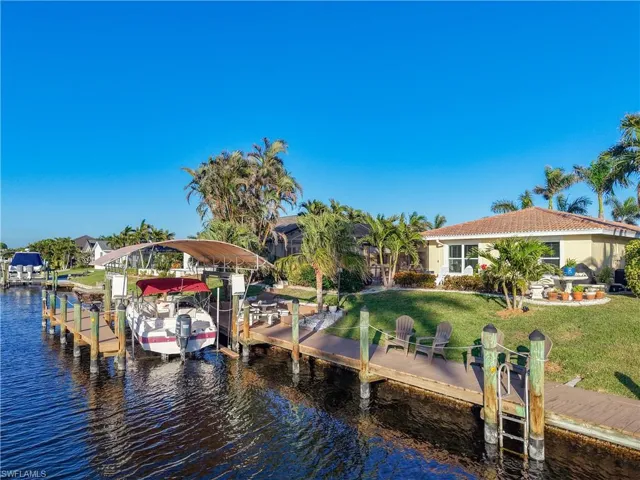 View of dock featuring a yard and a water view