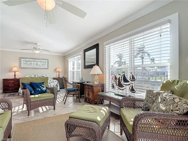 Bedroom with access to exterior, a raised ceiling, and ceiling fan