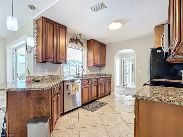 Kitchen with wood cabinets, granite counters and SS appliances