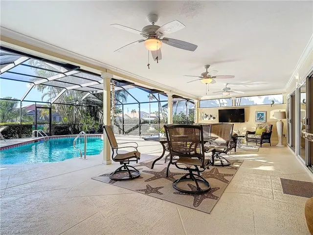 View of swimming pool with a patio area and a lanai