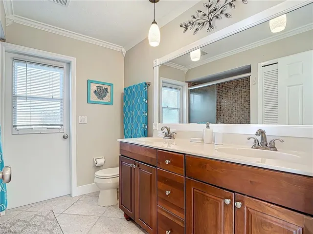 Bathroom with door to lanai and pool area