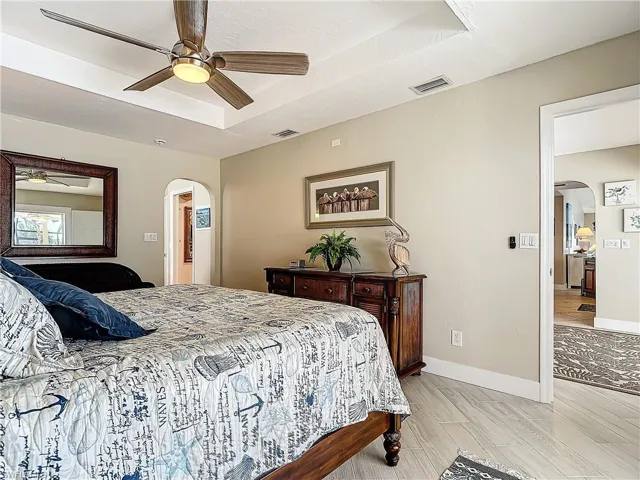 Bedroom featuring access to exterior, wood-type flooring, and ceiling fan