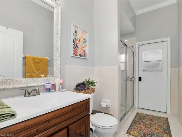 Third Full Bathroom with Walk-in Shower with Glass Enclosure, and Door to Lanai