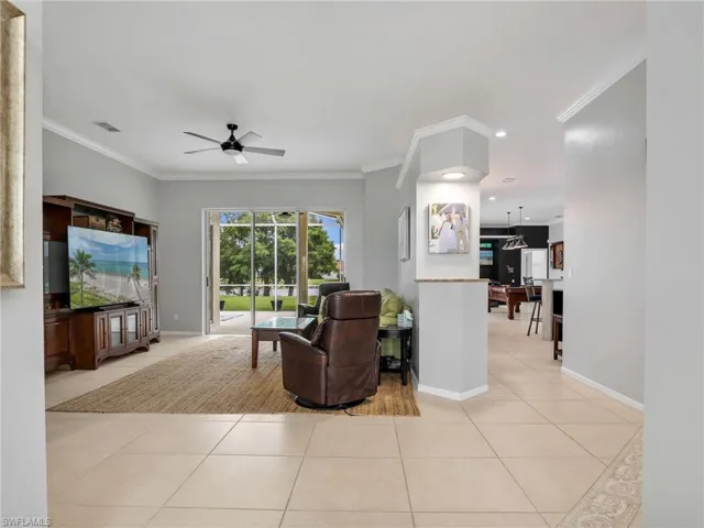 Living Room with Crown Molding and Ceiling Fan