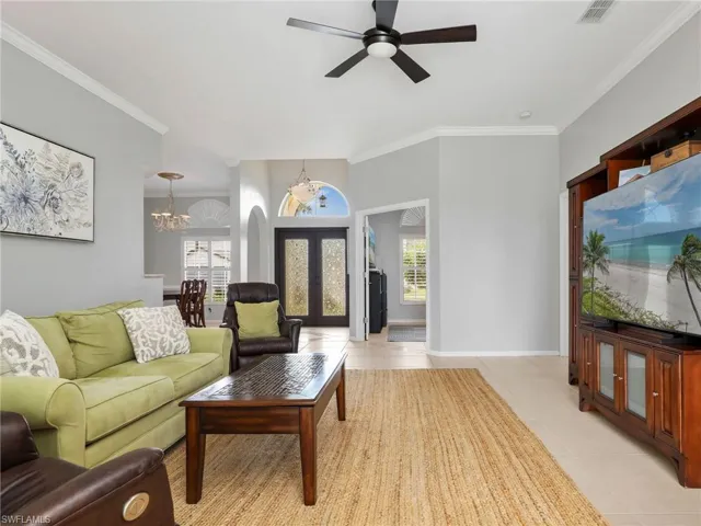 Living Room with Crown Molding and Ceiling Fan